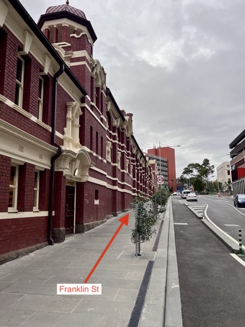 Franklin Street running alongside the red-brick heritage building