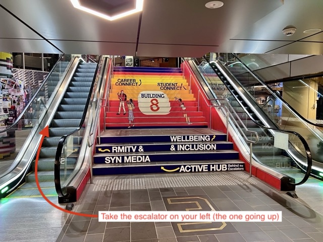 Building 8 escalators, take the up escalator on the left